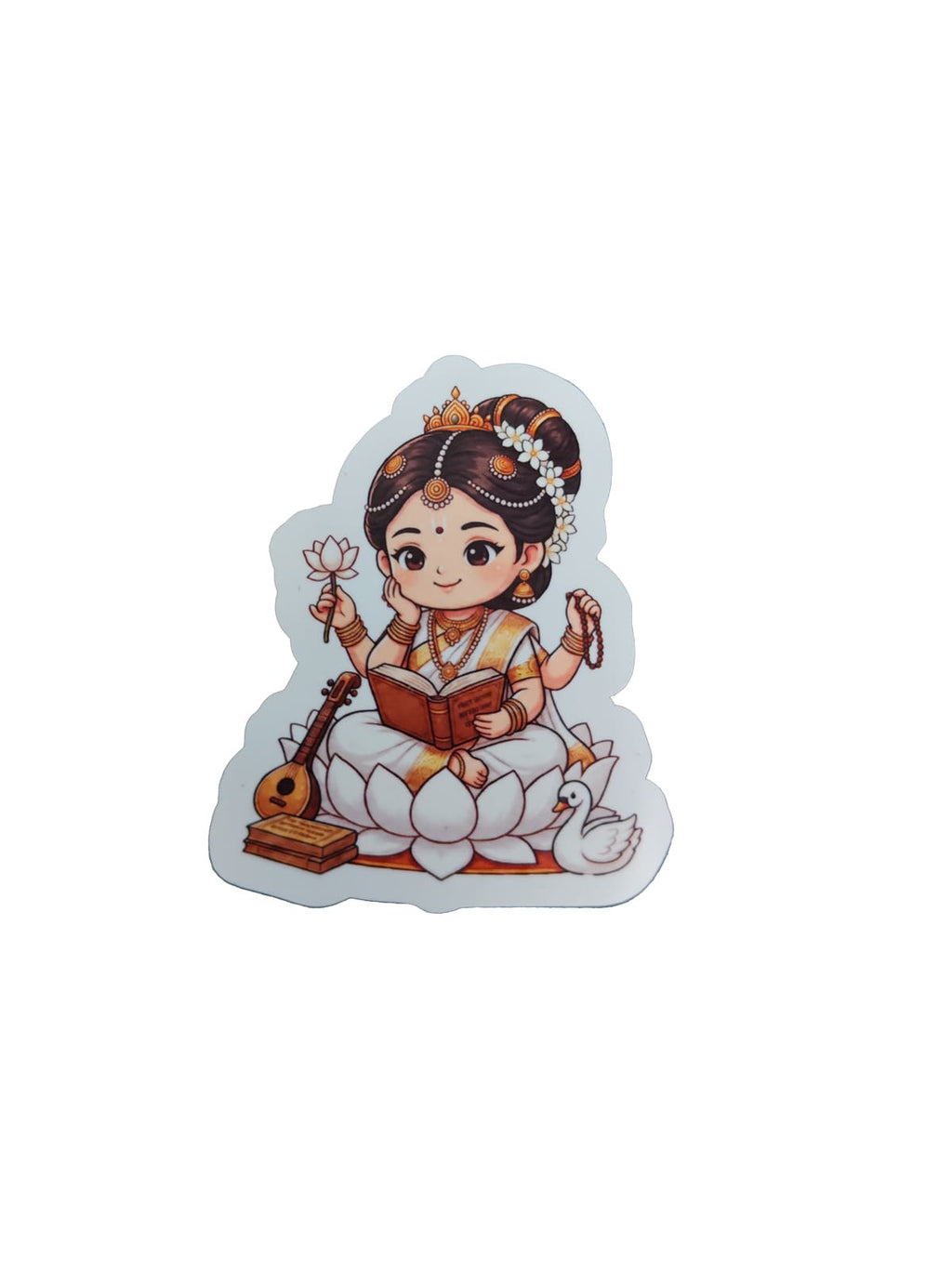 Chibi-style Goddess Saraswati devotional sticker featuring a lotus seat, veena, swan, book, lotus flower, and prayer beads on a black background.