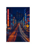 Tokyo City street at night with illuminated buildings and light trails