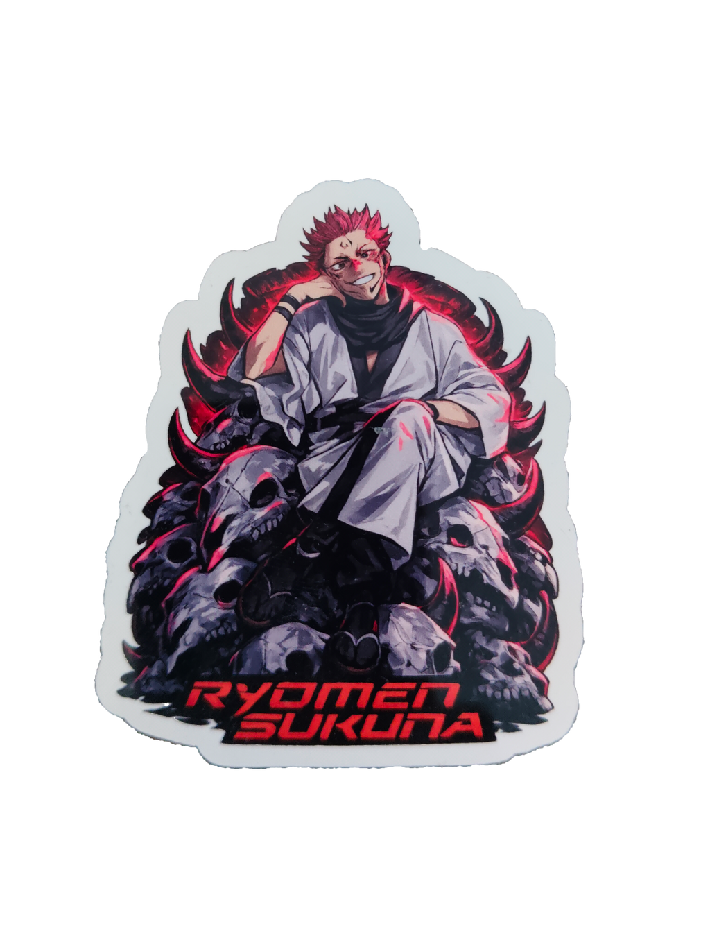 A die-cut sticker featuring an anime-style illustration of Ryomen Sukuna seated on a pile of skulls with glowing red accents, and the text 'RYOMEN SUKUNA' in red at the bottom, shown on a plain white background.