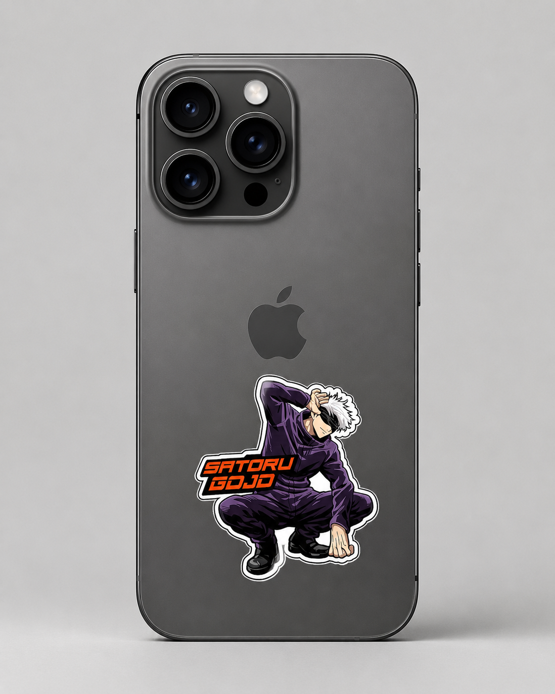 A dark gray smartphone case featuring a die-cut anime sticker of a character in a purple outfit with the text 'SATORU GOJO' in orange and black, shown on a phone against a neutral gray background.